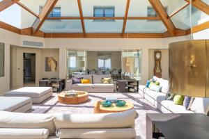 a large living room with white couches and a table at Majordoms Golf Peralada in Peralada