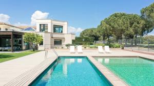a swimming pool in front of a house with a house at Majordoms Golf Peralada in Peralada