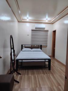 a bedroom with a bed in a room at Bon Joy Bed & Breakfast in Mabini