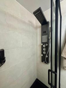 a bathroom with a shower with a hair dryer at SOLyMAR in Garrucha