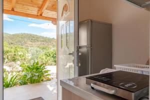 a kitchen with a refrigerator and a counter with a view at Nino's rooms in Ksamil