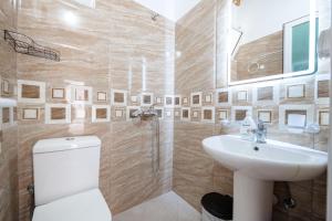 a bathroom with a toilet and a sink at Nino's rooms in Ksamil +20 photos