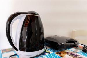 a black and white toaster sitting on a table at Nino's rooms in Ksamil