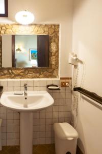 a bathroom with a sink and a mirror and a toilet at Il Castello di San Sergio in Centola +79 photos