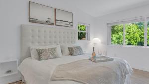 a white bedroom with a large bed and two windows at 812 Mariners Club in Key Largo +44 photos