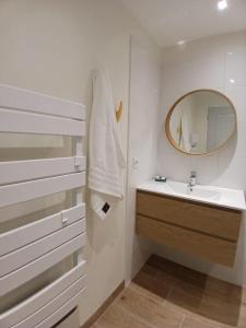 a bathroom with a sink and a mirror at La maisonnette in Saint-Georges-de-Luzençon +34 photos