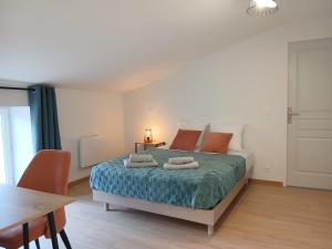a bedroom with a bed with two pillows on it at La maisonnette in Saint-Georges-de-Luzençon