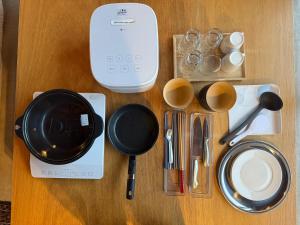 a table with utensils and cups and a blender at anandahの宿 in Miyazaki +72 photos
