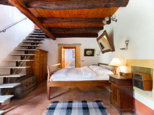 a bedroom with a bed and a staircase at Locanda L'Amorosa in Sementina