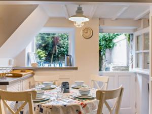 a kitchen with a table and chairs and a window at 2 Bed in Brixham oc-bx021 in Brixham +13 photos