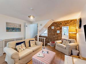 a living room with two couches and a brick wall at 2 Bed in Brixham oc-bx021 in Brixham