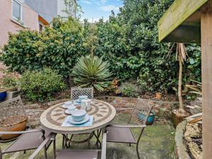 a table and chairs in a backyard with a garden at 2 Bed in Brixham oc-bx021 in Brixham