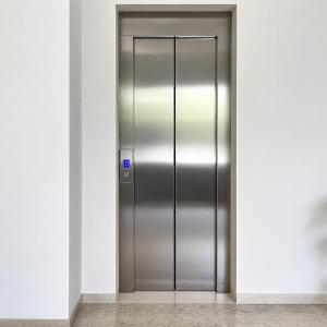 an elevator door in a building with a blue sign at M9 Rest House Venice in Mestre
