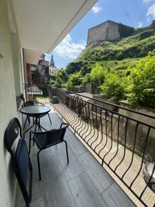 a balcony with a table and chairs and a view at Apartament W Cieniu Twierdzy in Kłodzko