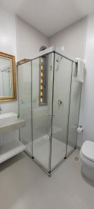 a bathroom with a glass shower with a toilet at Pousada Buona Serata in Bento Gonçalves +61 photos