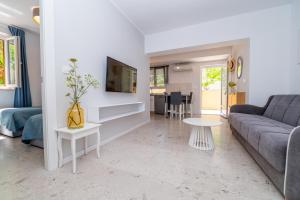 a living room with a couch and a table at House Rosa in Mali Lošinj