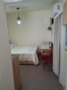 a room with a bed and a table with a chair at Shorena apartments in Tbilisi City +1 photo