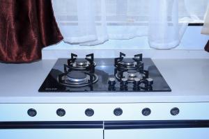 a stove top with two burners on top of it at Malkia Exquisite Homes in Nairobi