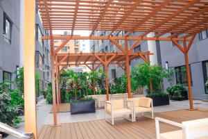 a wooden pergola in the middle of a building at Malkia Exquisite Homes in Nairobi