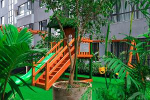 an orange playground with a slide in a garden at Malkia Exquisite Homes in Nairobi