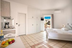 a kitchen and a bedroom with a bed in a room at Hotel Caretta Beach in Gerani +61 photos