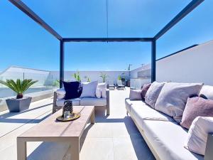 a living room with a couch and a table at Casa Colisa - 8610 in San Javier