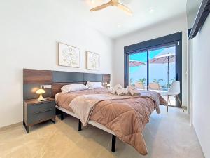 a bedroom with a large bed and a large window at Casa Colisa - 8610 in San Javier +36 photos