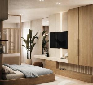 a bedroom with a bed and a flat screen tv at Le Onde Studio in Durrës