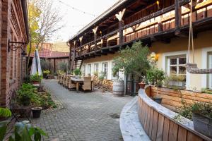 a patio with a table and chairs and a building at II Bramasole - Sophia L in Spreewitz