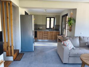 a living room with a couch and a kitchen at my suite home in Heraklio +7 photos
