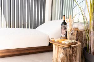a table with a bottle of wine and cheese at Luxury Experience Suites in Toledo