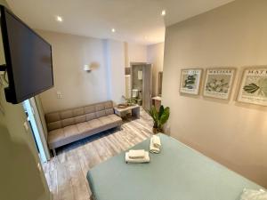 a living room with a couch and a flat screen tv at AVLI Sarti Studios & Apartments no2 in Sarti