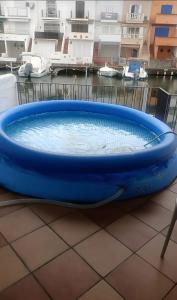 a large blue tub sitting on a tile floor at Port Empúries in Empuriabrava