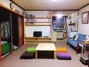 a living room with a couch and a table at MEGANE HOUSE First floor All private in Rankoshi