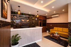 a bar in a restaurant with a yellow couch at Heaven Suite in Kalpetta