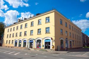 a large yellow building on the corner of a street at Riga Street Apartments in Valmiera - 20 in Valmiera