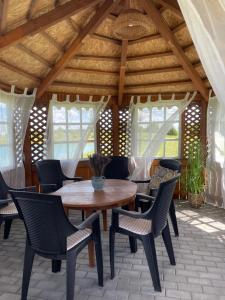 a patio with a wooden table and chairs at Nameliai TRES in Bernotiškė