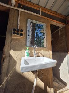 a bathroom with a sink in a house at Alex Tribe Cafe and Funstay in Sainj