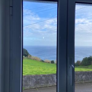 a view of the ocean from a window at Angelic Sea View in Bretanha
