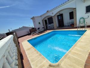 a swimming pool on the roof of a house at Casa Abuela Encarna in Hornachuelos