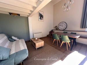 a living room with a bed and a table and chairs at Edelweiss in Apchon