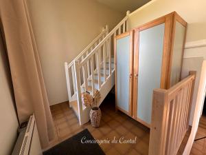 a stairway with a vase sitting on the floor at Edelweiss in Apchon
