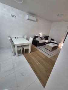 a living room with a table and a couch at Apartman Sunce in Posušje +23 photos