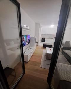 a view of a living room with a flat screen tv at Apartman Sunce in Posušje