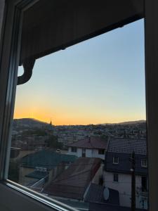 a view from a window of a city at sunset at Villa Aba apartments in Sarajevo