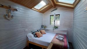 a small bedroom with a bed in a tiny house at NEW Family Villa ideal para familias in Pineda de Mar +52 photos