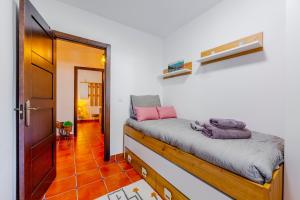 a small room with a bed and a hallway at Tu Descanso en Ohanes in Ohanes