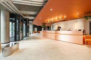 a lobby of a building with a reception counter at ECLA Paris Massy Palaiseau in Palaiseau +48 photos