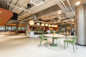 an office space with a table and chairs and a counter at ECLA Paris Massy Palaiseau in Palaiseau