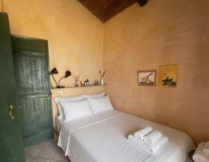 a bedroom with a bed with two towels on it at Olive House Galaxidi in Galaxidi